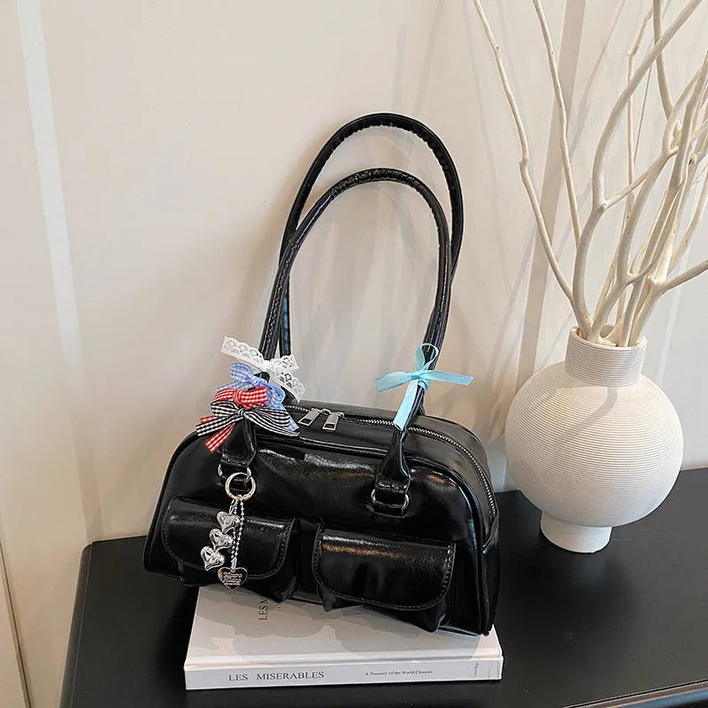 Pillow-shaped PU leather women's handbag in black with ribbon pendant and double shoulder strap