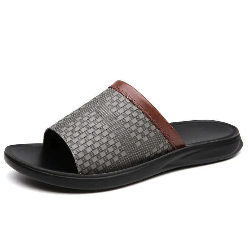 Men's breathable PU leather slippers in black with flat heel and round toe, side view
