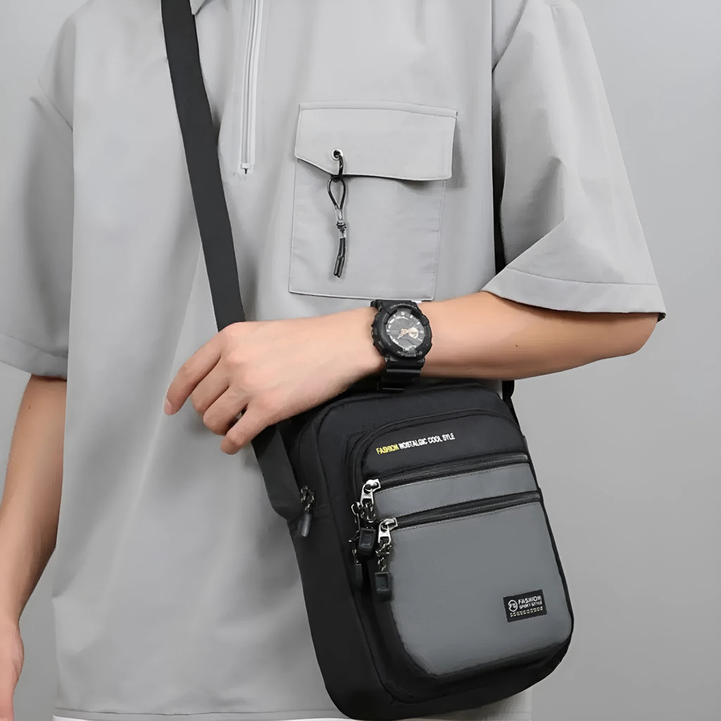 Men's nylon crossbody bag in solid colour with visible stitching, shown in green.
