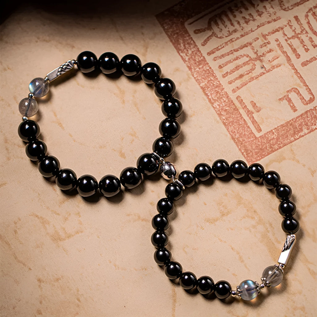 Obsidian Buddha beads couple bracelet set showing 10mm men's and 8mm women's Tibetan style bracelets