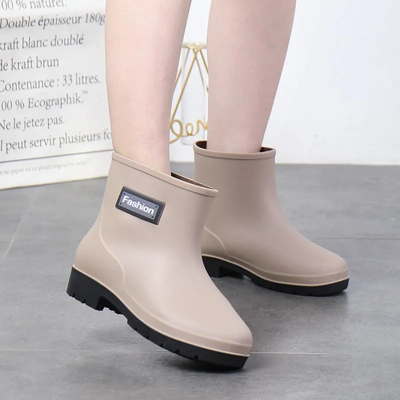 Women's PVC rain boots in black with mid-calf height and low heel design