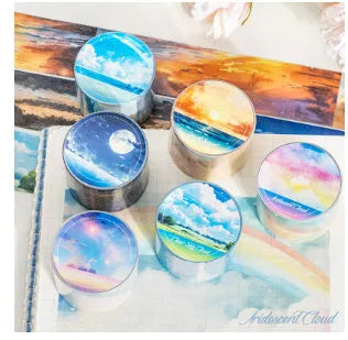 Roll of Japanese paper decorative tape with sky theme patterns including clouds, sun, moon, and nebula.