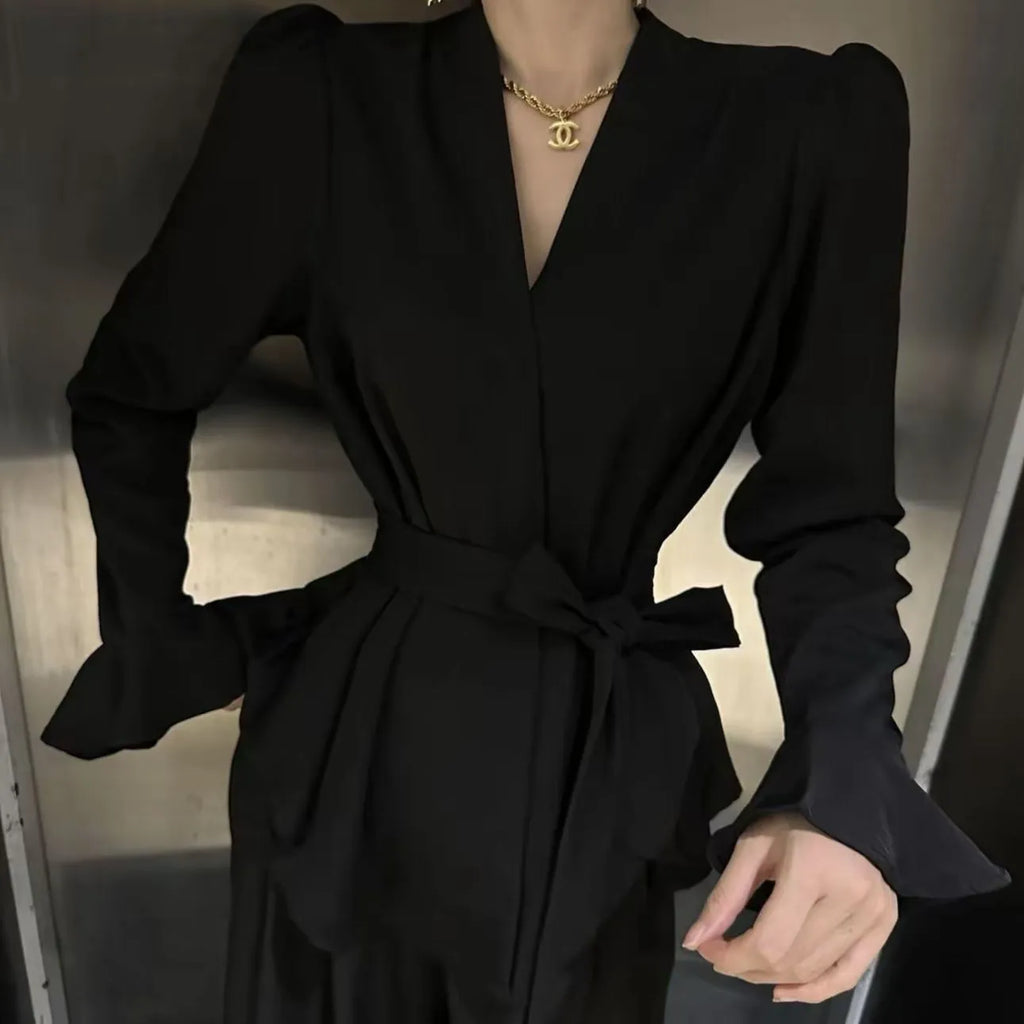 Women's black French-style shirt with irregular collar and tied waist detail featuring bell sleeves