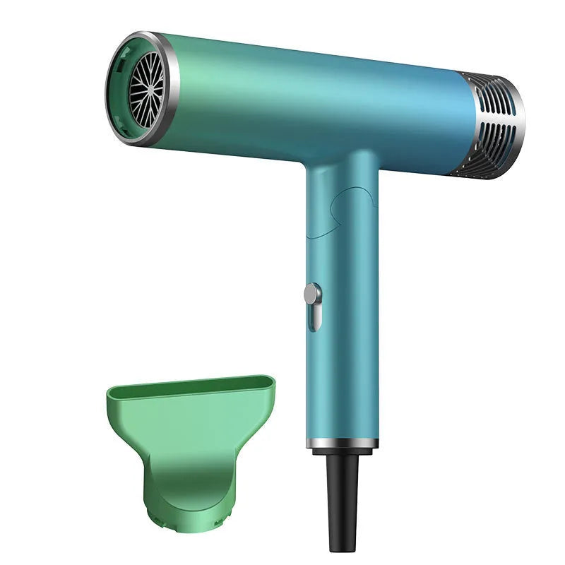 Green foldable hair dryer with collapsed handle next to a suitcase