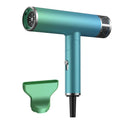 Green foldable hair dryer with collapsed handle next to a suitcase