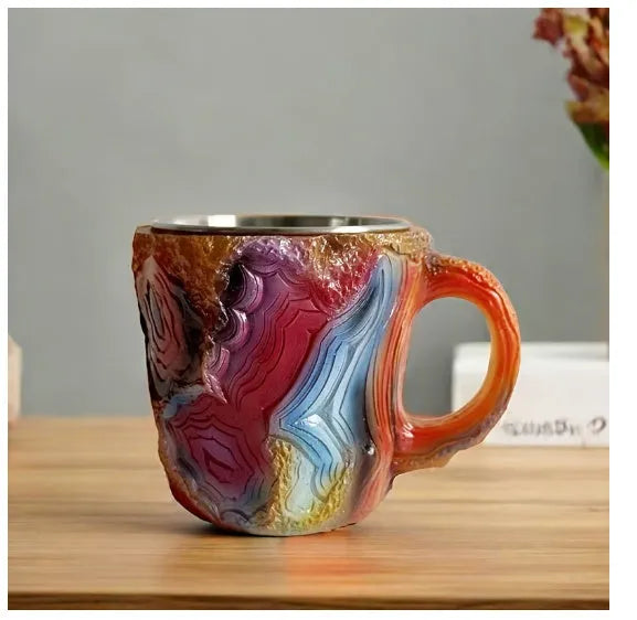 Purple and blue resin coffee mug with crystal texture and handle on wooden table