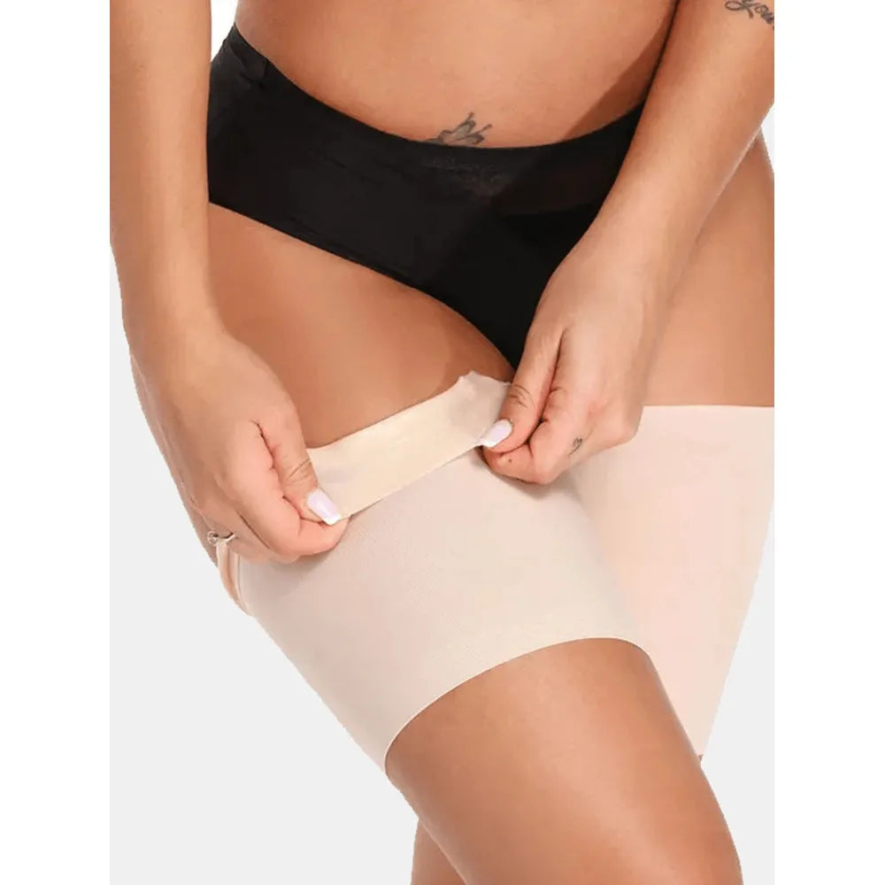 Women's anti-friction silicone thigh strap in black with adjustable nylon band on plain background