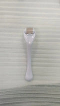 Mechanical micro needle roller device with coloured handle and wheel on a white background
