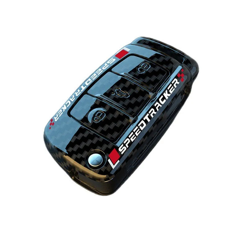 Carbon fibre pattern car key cover with a small rectangular mirror set into the feilin material casing.