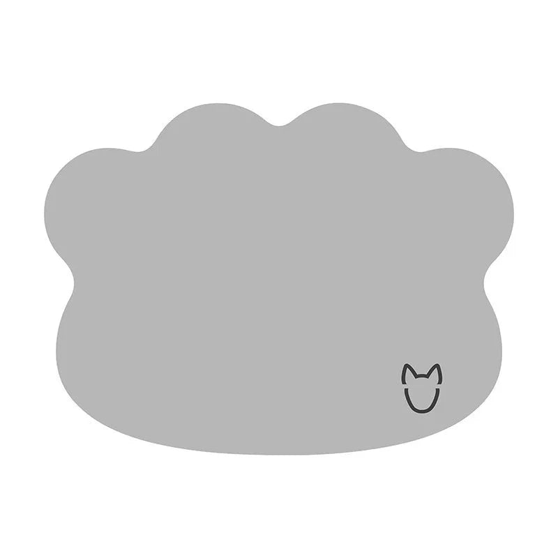 Dog cooling mat made of ice silk in a dog head shape, shown in light grey on a wooden floor.