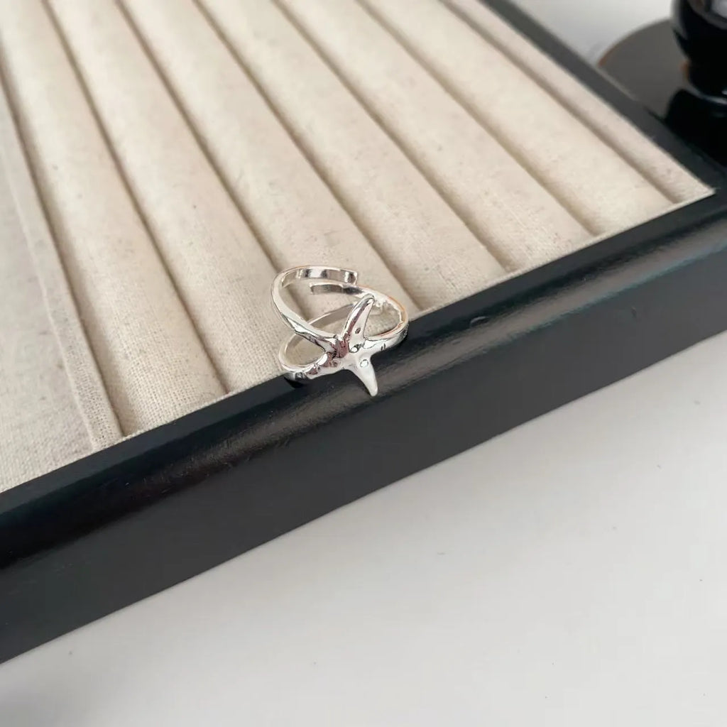 Open silver-tone ring with a 3D jasmine flower and multiple small flowers on the band.