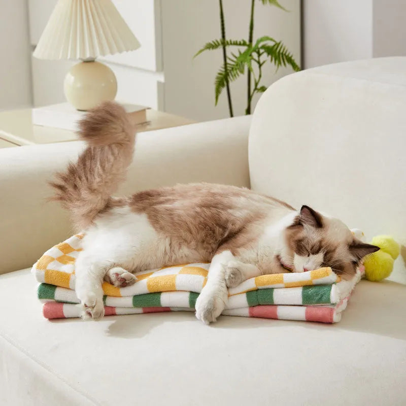 Plush fleece pet blanket with plaid pattern and fur ball decoration for cats and dogs