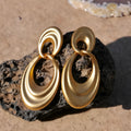 Gold coloured double circle French retro earrings with a U-shaped design and quicksand finish.