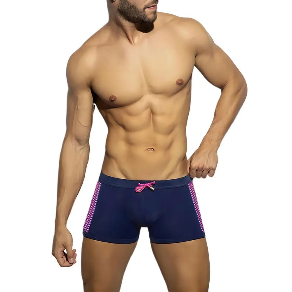 Men's black polka dot quick-dry swimming boxers briefs on a white background.