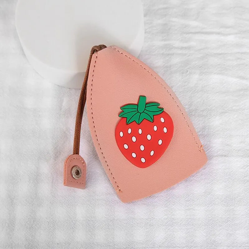 Colourful cartoon pull-out key protector case made from PU leather, showing a selection of fruit and animal designs.