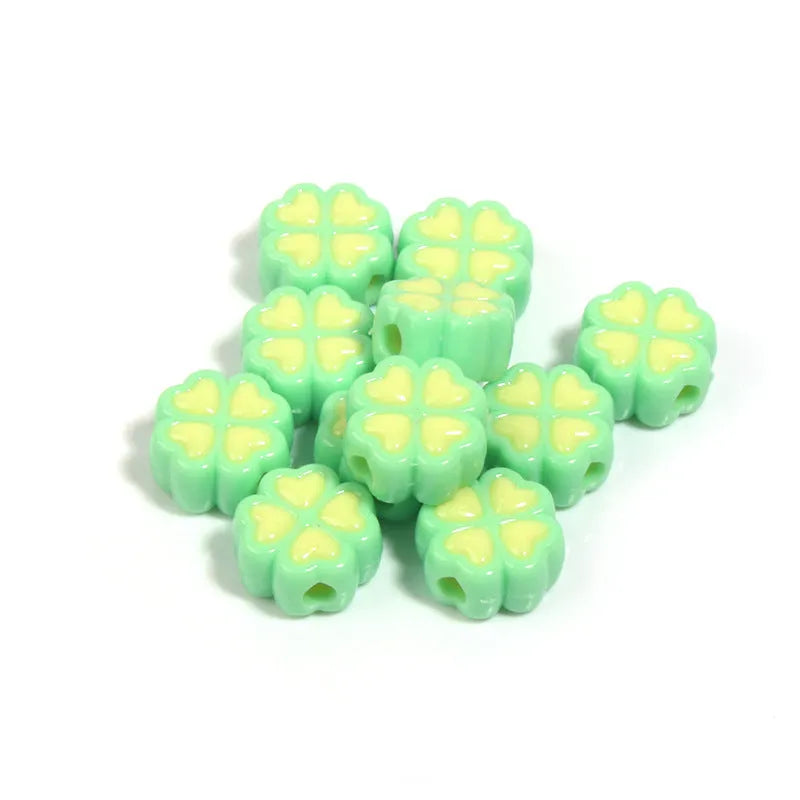 Mixed colour frosted acrylic four-leaf clover shaped beads, each 15mm in size.