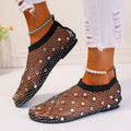 Women's flat sandals with colourful rhinestones on a mesh upper and a rubber sole.
