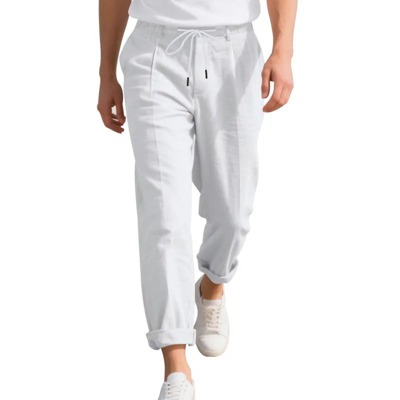 Man wearing light khaki straight-leg linen trousers with a drawstring waist.