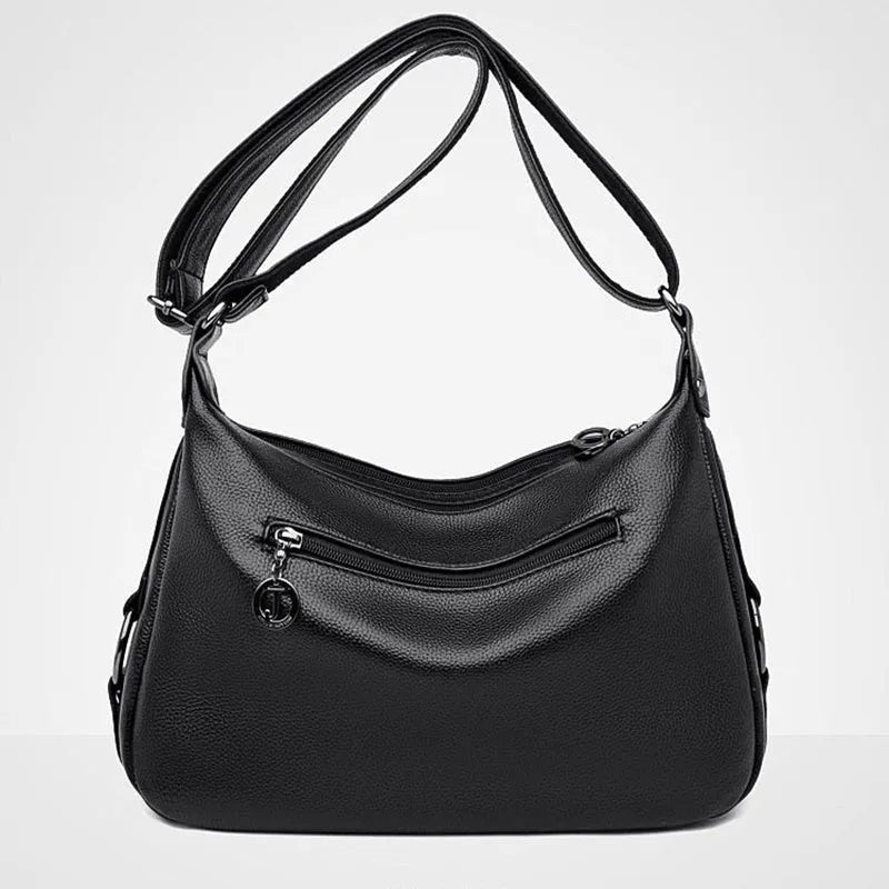 Large black women's shoulder bag with multiple compartments and luggage-inspired styling