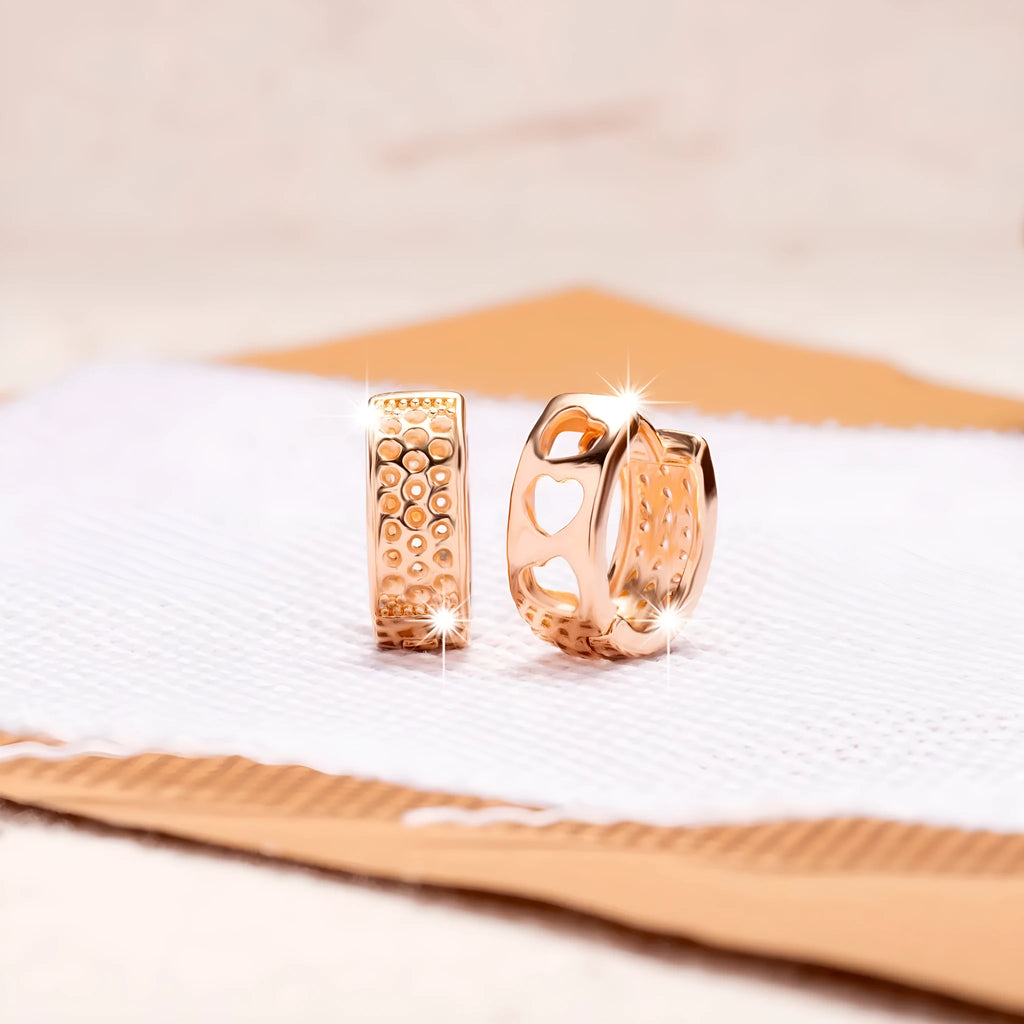 Rose gold electroplated women's earrings with three hollowed heart shapes in circular arrangement