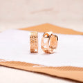 Rose gold electroplated women's earrings with three hollowed heart shapes in circular arrangement