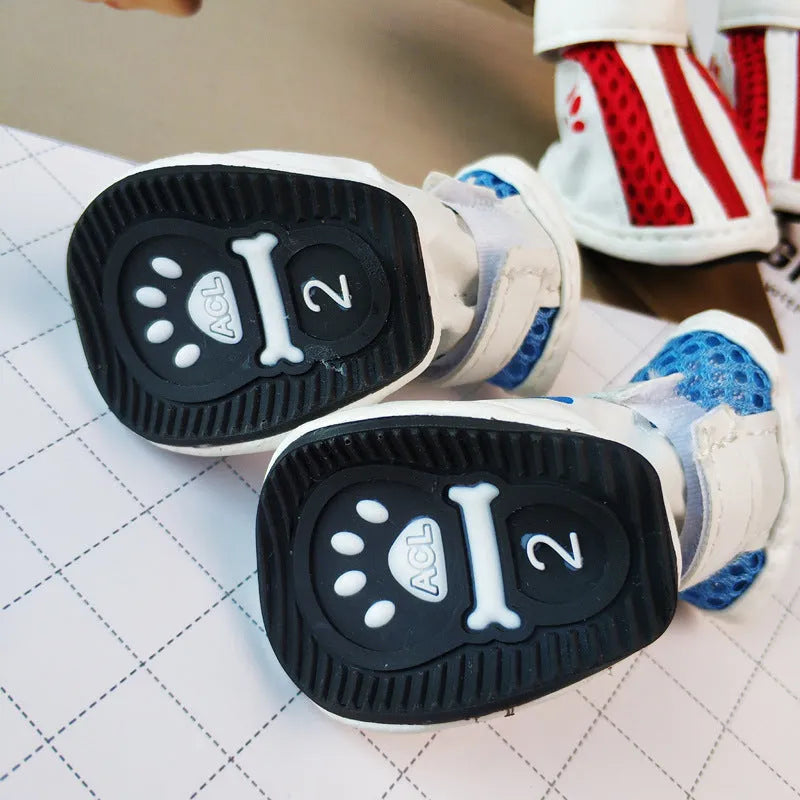 Set of four blue cloth dog shoes with zipper fastening and non-slip soles for small pets.