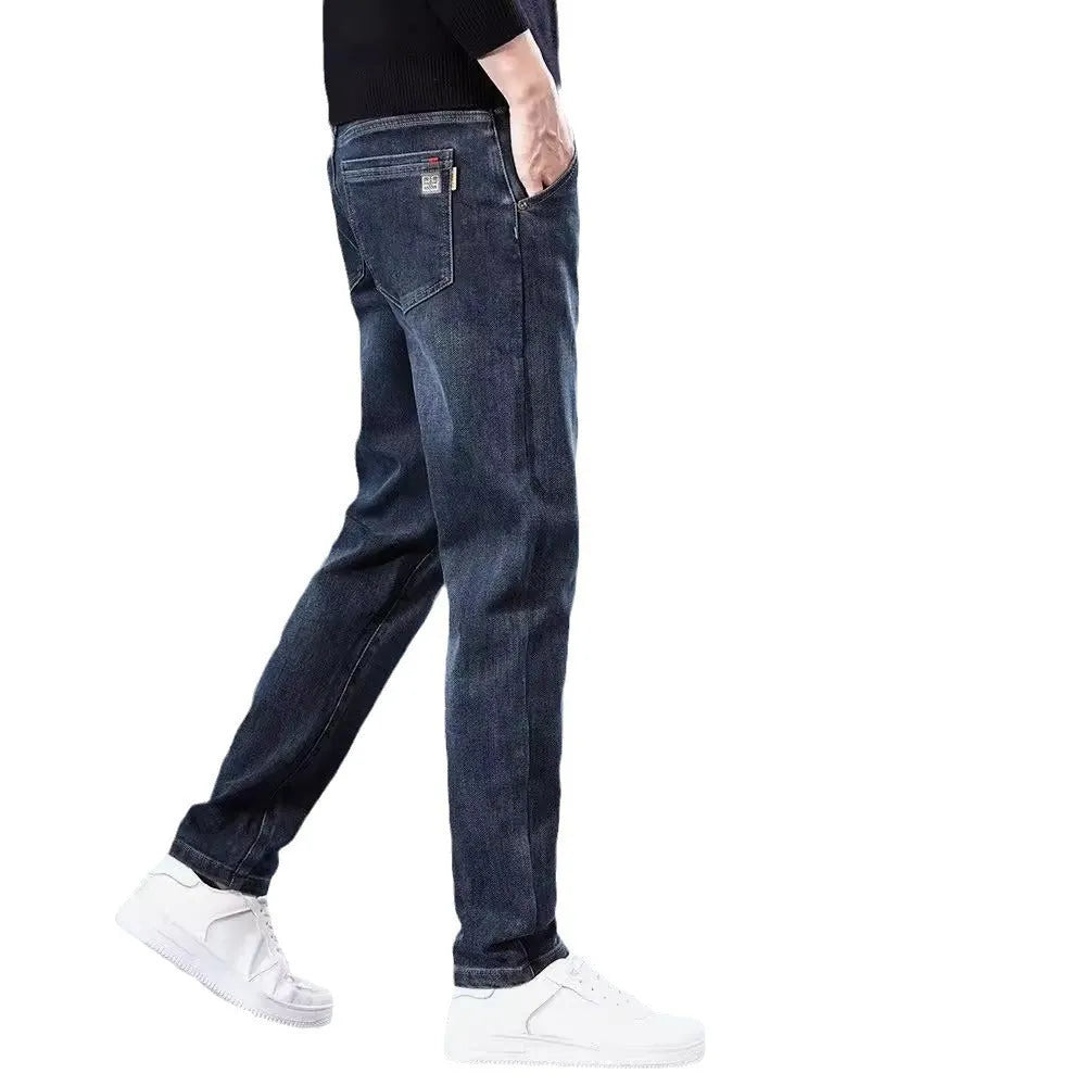 Blue grey slim straight casual trousers with a mid waist and zip fly on a neutral background.