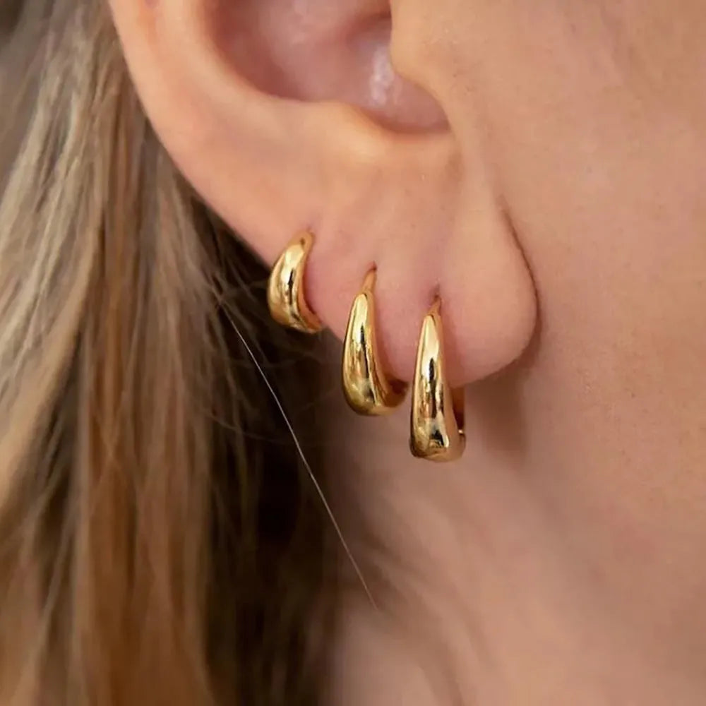 Three glossy geometric copper earrings set in gold electroplated finish