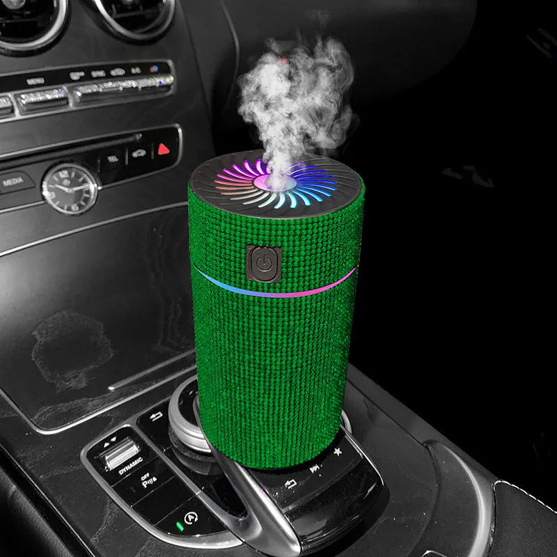 Compact white car air purifier and humidifier unit mounted on a car air vent.
