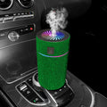 Compact white car air purifier and humidifier unit mounted on a car air vent.