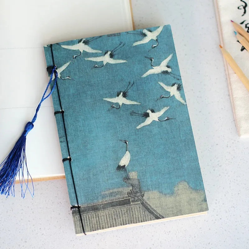 Antique wire-bound notebook with embossed cowhide cover and black wax rope binding