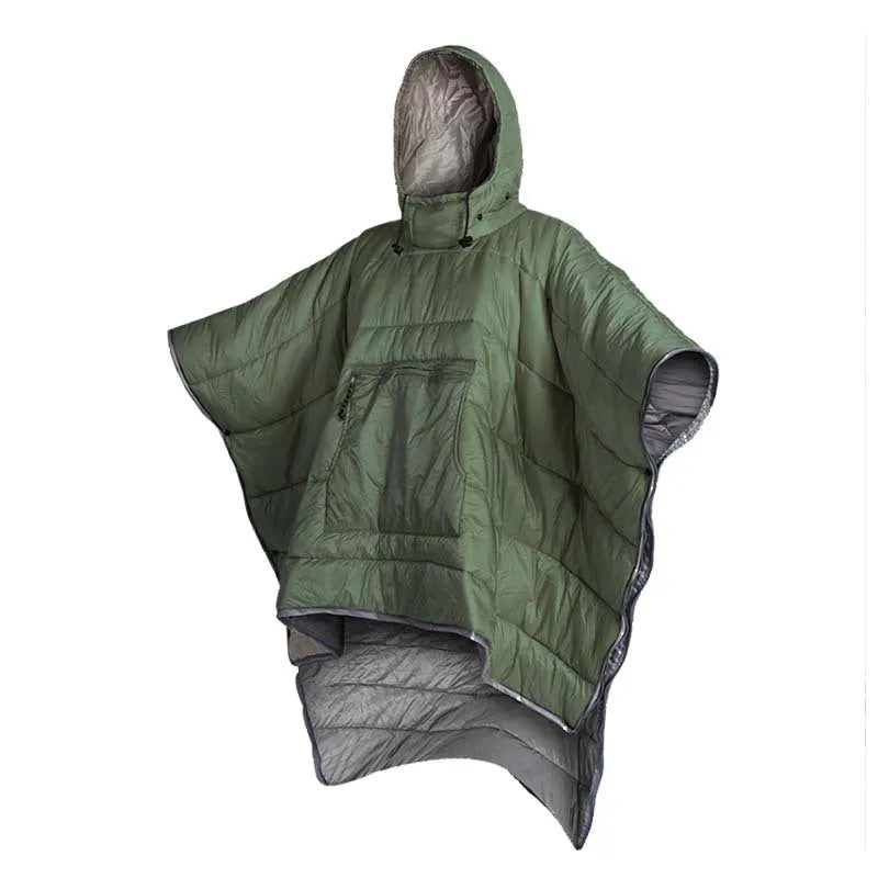 Adult wearing grey nylon cloak sleeping bag as wearable camping blanket outdoors