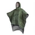 Adult wearing grey nylon cloak sleeping bag as wearable camping blanket outdoors