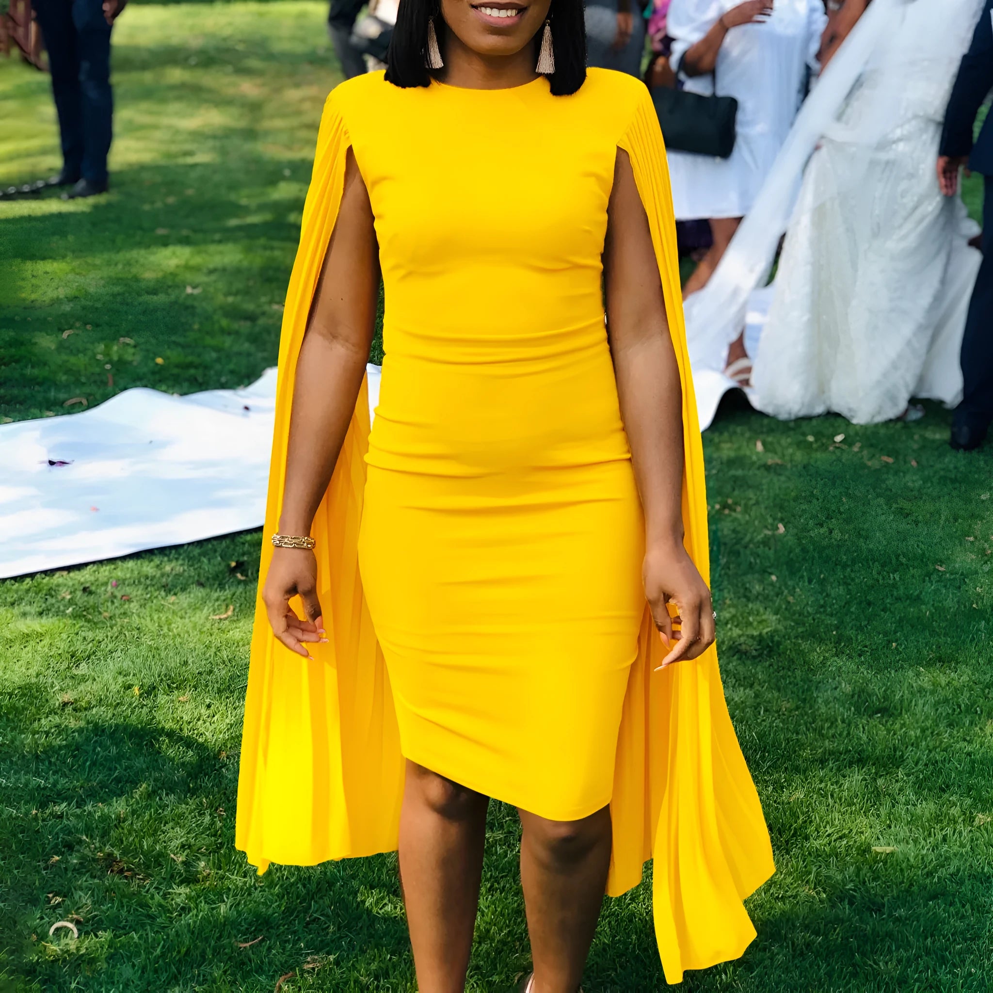 High-waisted polyester evening gown with long sleeves and pleated skirt in yellow colour