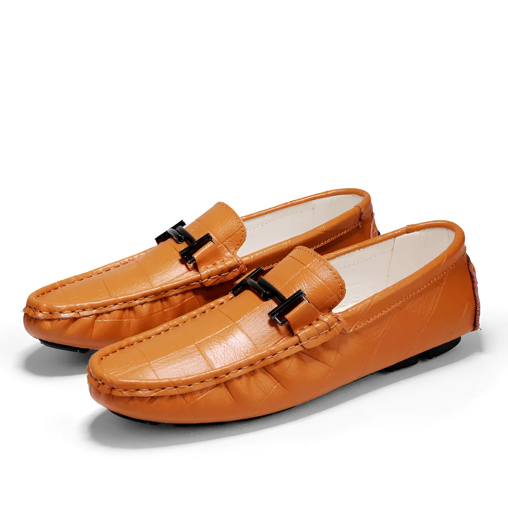 Men's brown leather casual loafers with a silver buckle on the upper, shown on a white background.