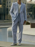Blue and white striped polyester blazer and trousers suit set laid flat.