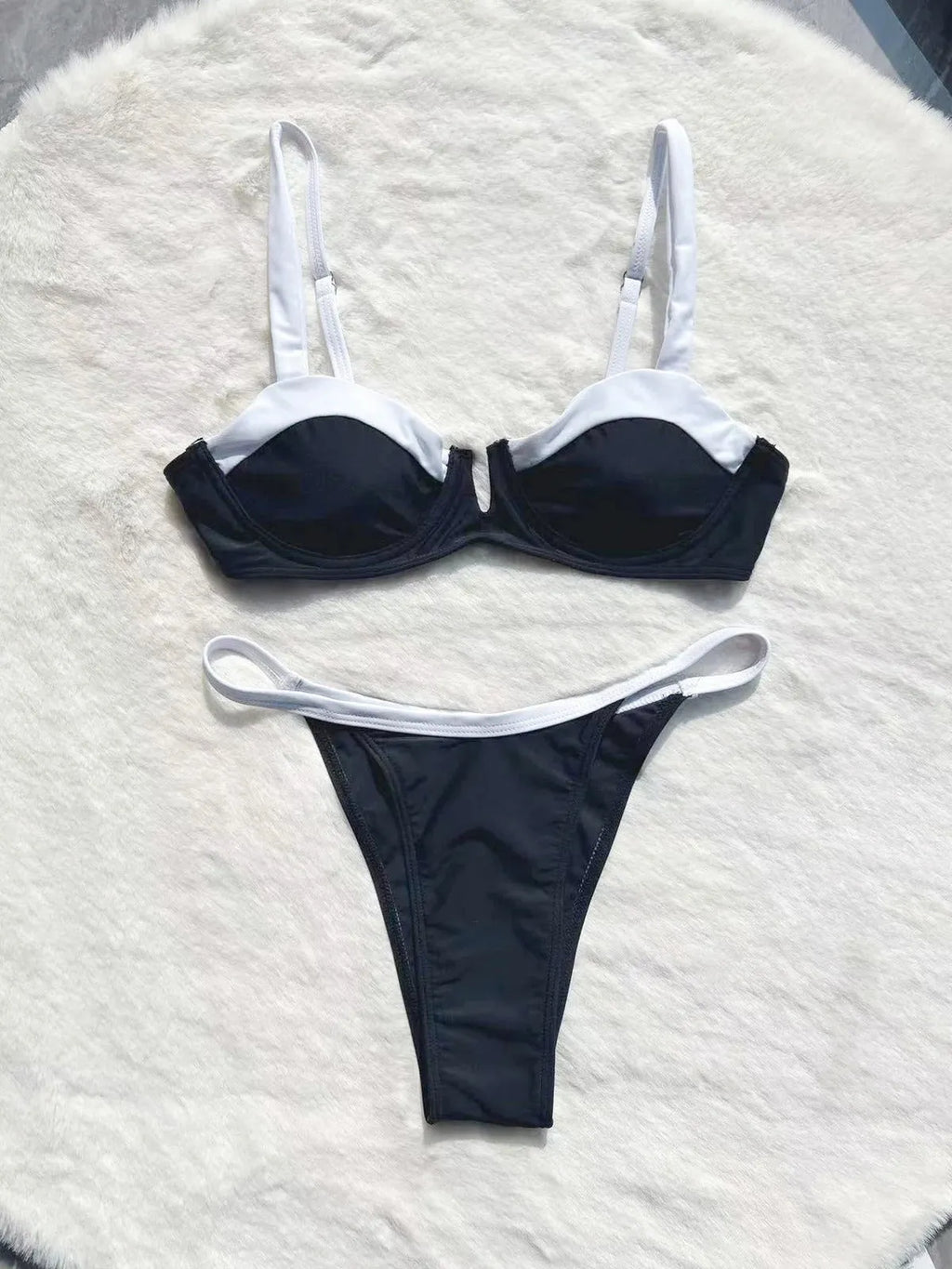 Black low-waist bikini swimsuit for women with split leg stitching, shown as a full set.