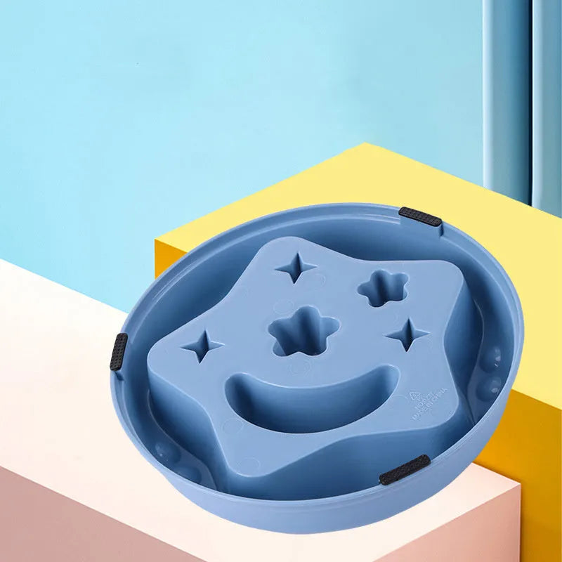 Large blue dog bowl with raised moon and star shapes inside as a slow feeder