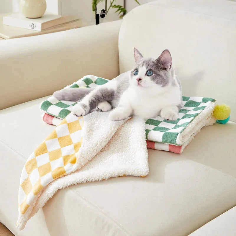 Plush fleece pet blanket with plaid pattern and fur ball decoration for cats and dogs