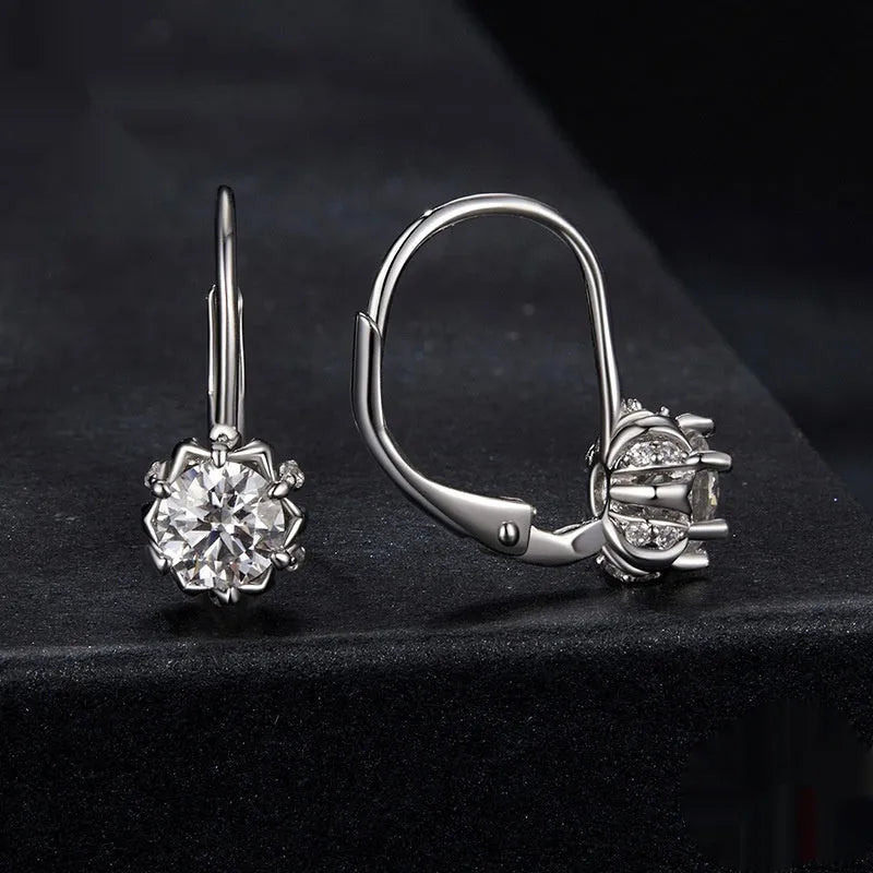 Close-up of a sterling silver flower bud ear clip with a white gold plated finish and a central 0.5 carat moissanite stone.