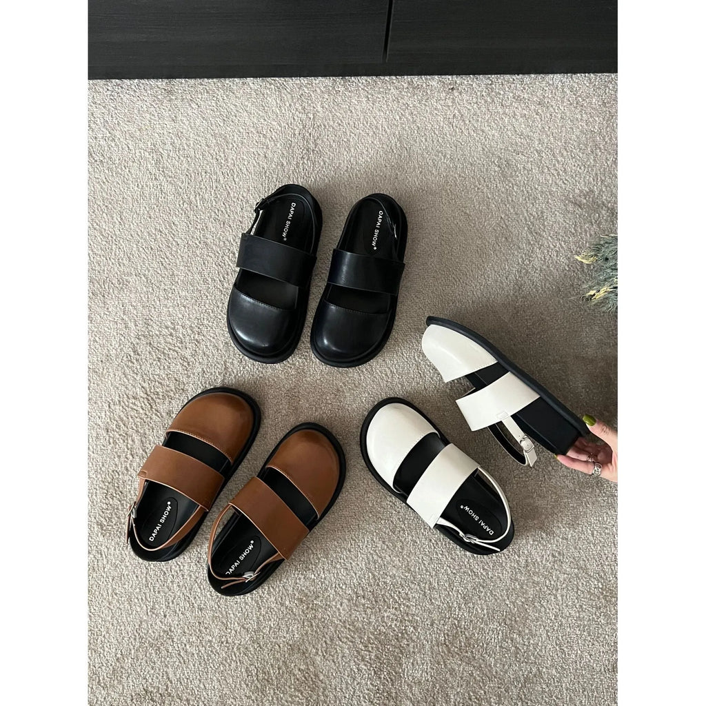 Retro closed toe sandals with an ankle buckle in apricot colour on a white background