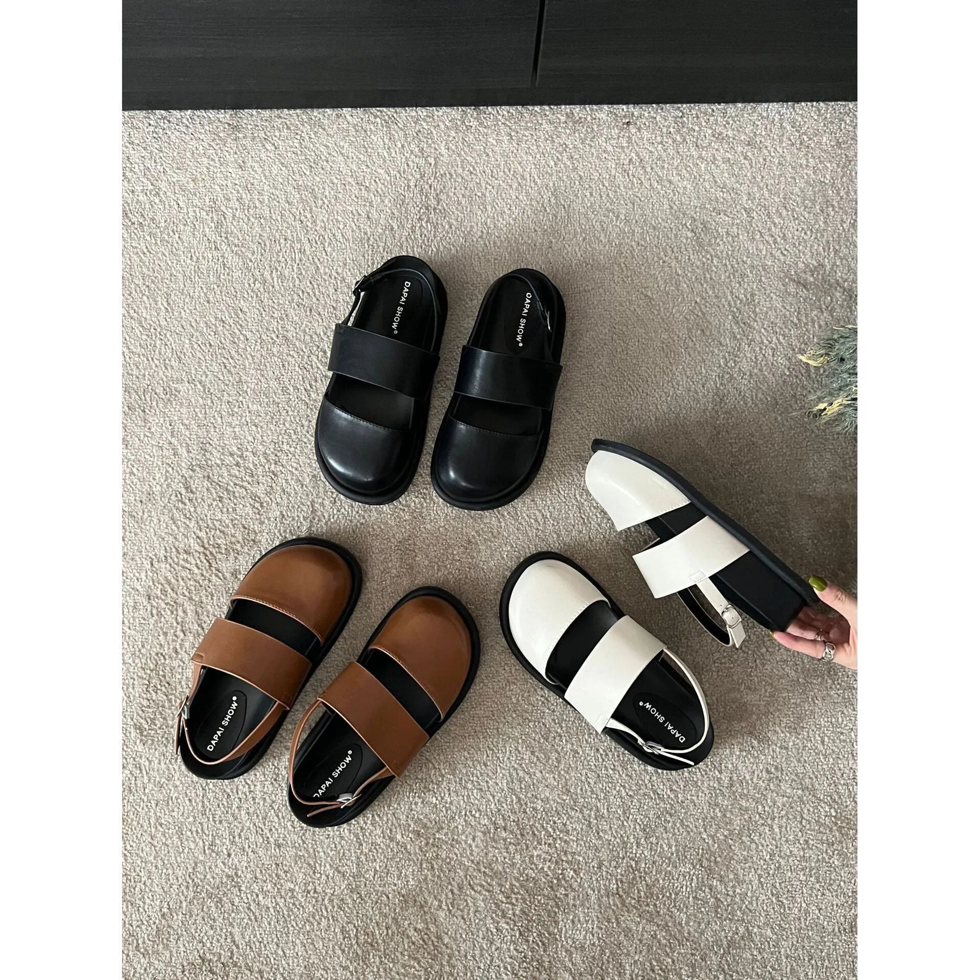Retro closed toe sandals with an ankle buckle in apricot colour on a white background