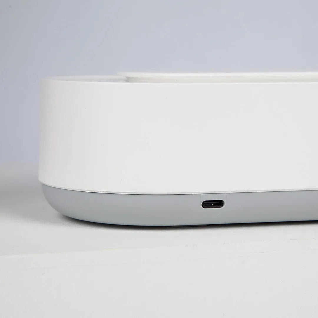 White portable ultrasonic cleaner with digital display and stainless steel cleaning tank.