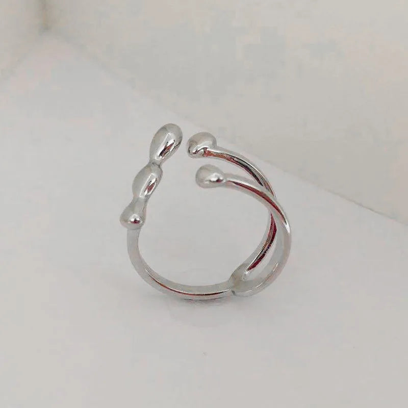Adjustable opening brass fashion ring with circular sphere decoration in gold or silver finish