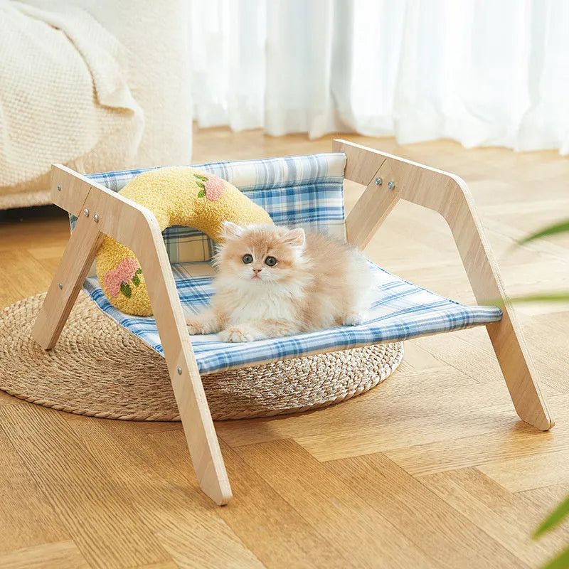Wooden frame cat hammock bed with soft blue cloth on a wooden beach chair structure