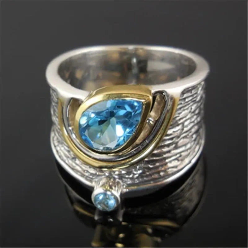 Blue drop-shaped women's ring with inlaid zircon rhinestones on an alloy band.