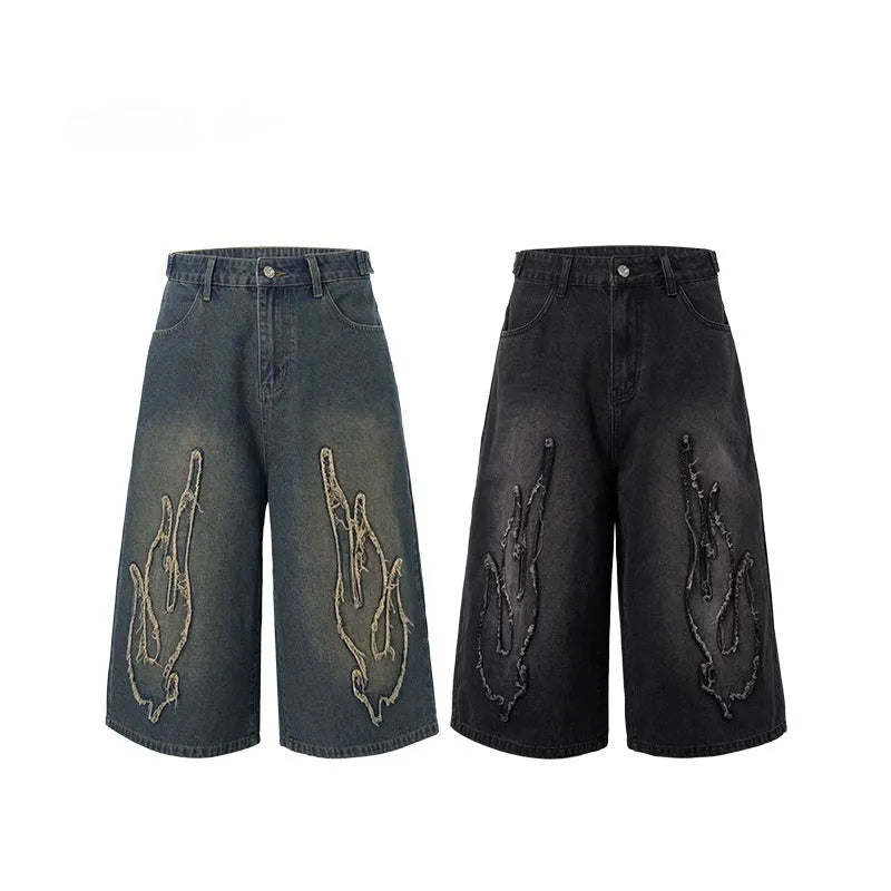 Men's black denim shorts with flame embroidery patch, cropped length and straight fit streetwear style