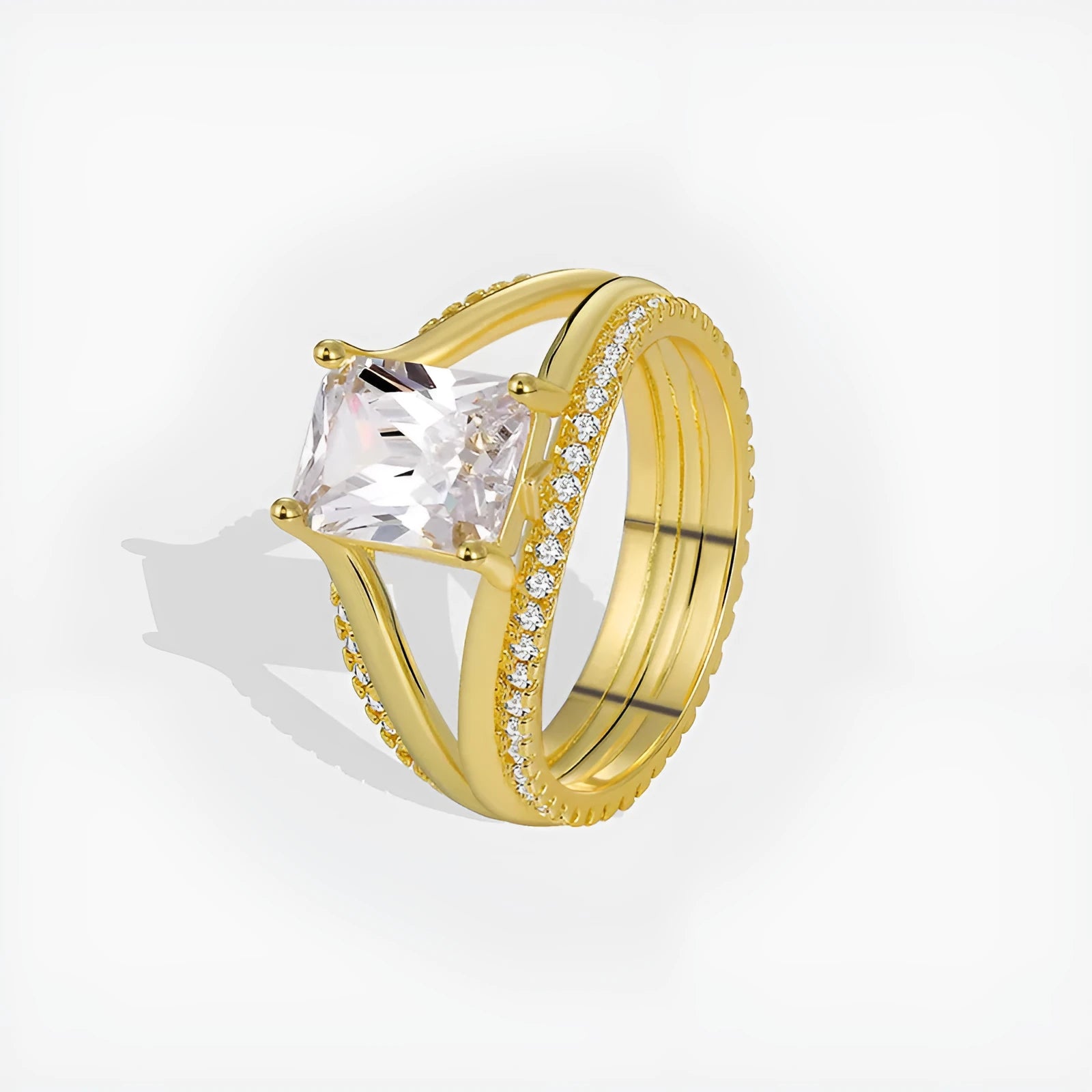 Gold-coloured geometric women's ring with a square zircon stone, shown on a finger.