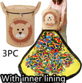 Green felt cube storage bag with pull rope closure lying flat as a play mat.