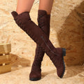 Black lace-up over the knee flat heel boots with stitching details on a round toe.
